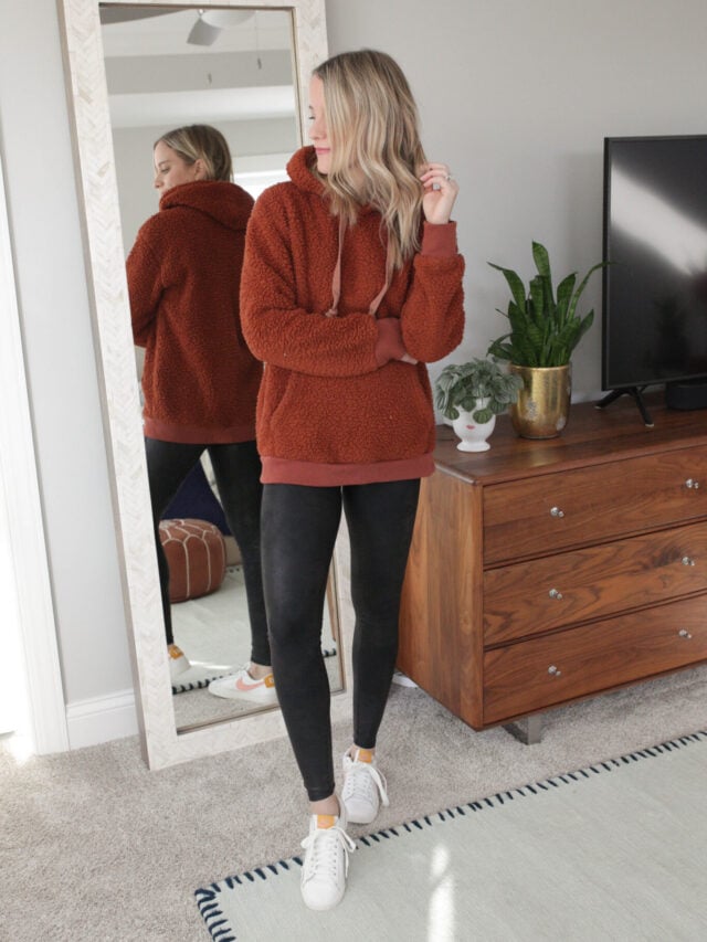 faux leather leggings with longer sweatshirt and white sneakers