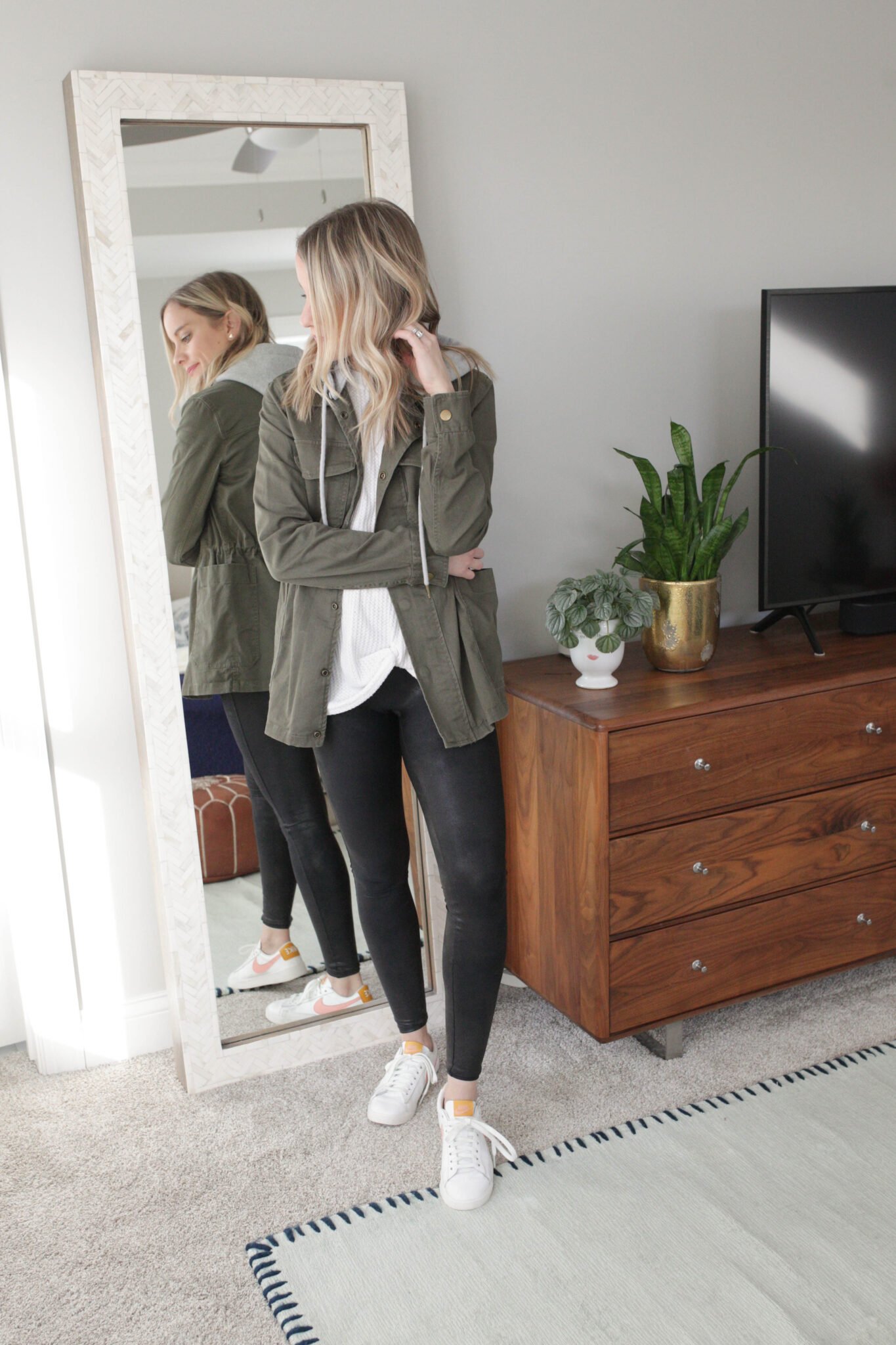 faux leather leggings, white sneakers, green jacket and white top