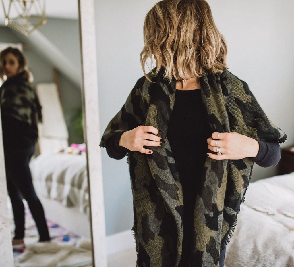 woman in blanket scarf turning head