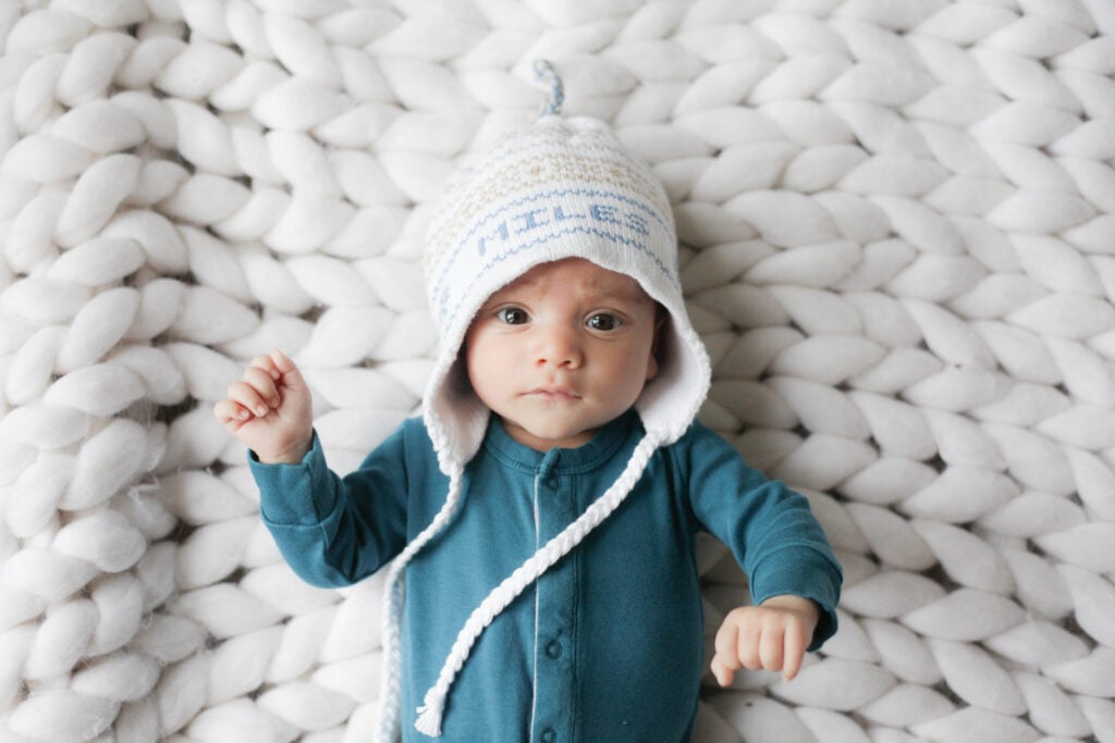 baby in colored organics pajamas and hat
