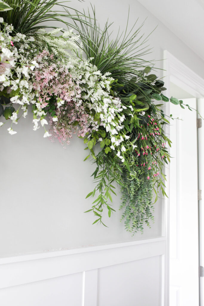 DIY Faux Greenery Wall Hanging - Paisley & Sparrow  Greenery wall decor,  Flower wall backdrop, Flower wall decor