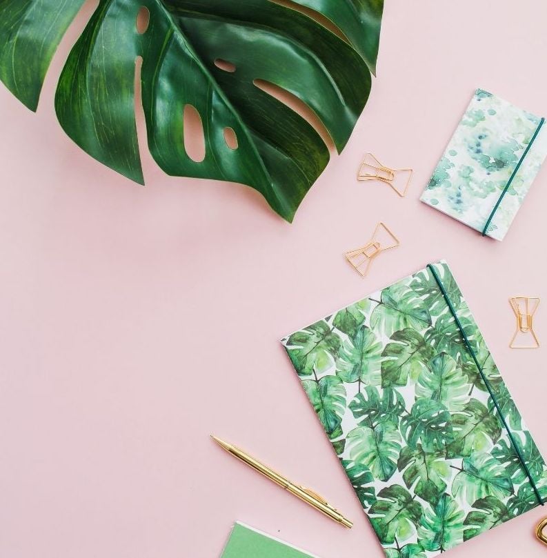 Bullet journaling supplies on pink background