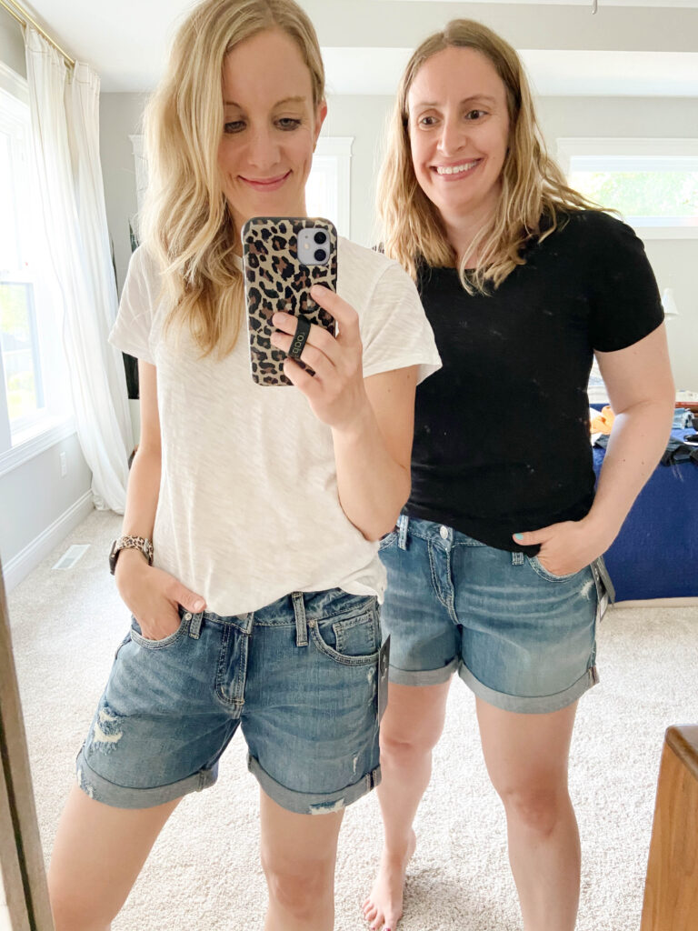 Two women wearing cuffed denim jean shorts