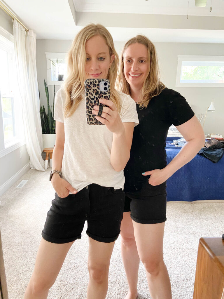 Two women wearing black denim shorts