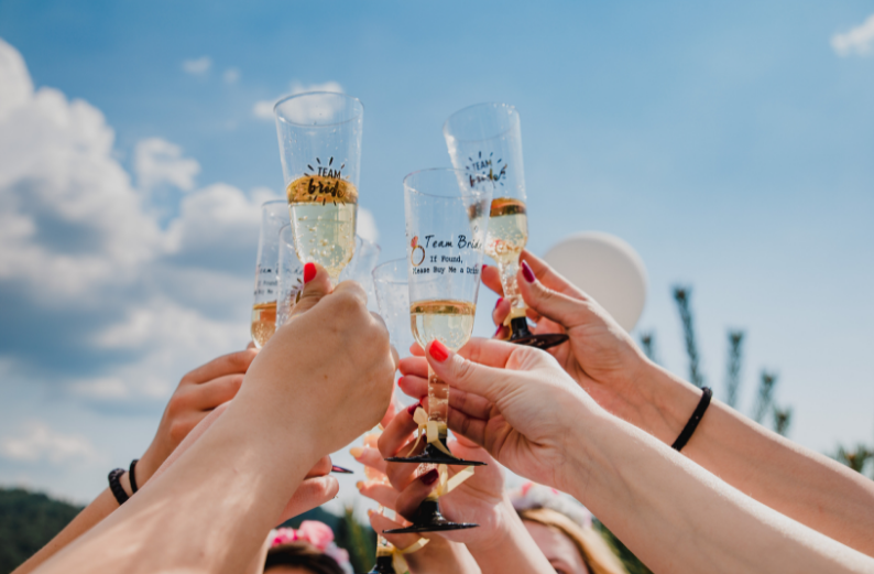 hands holding champagne glasses