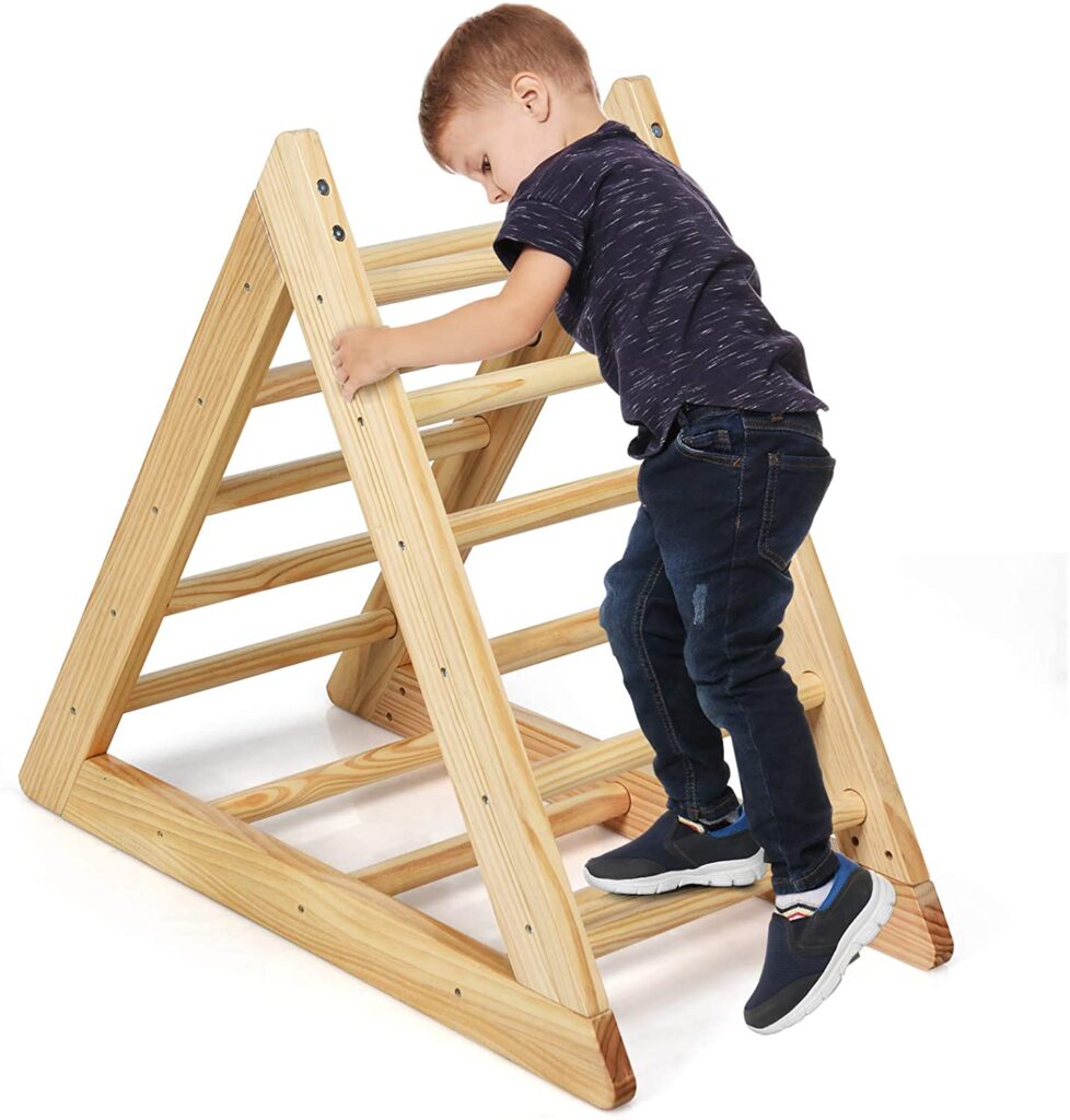 Kid playing on wooden triangle