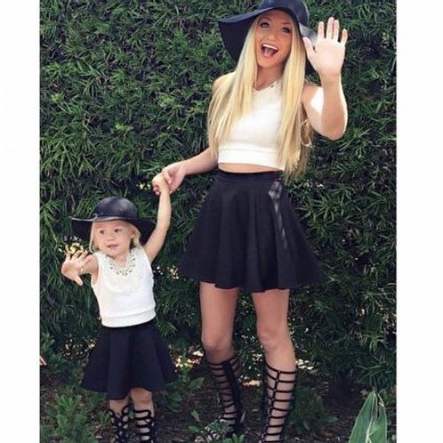 Mom and little girl in matching black skater skirts