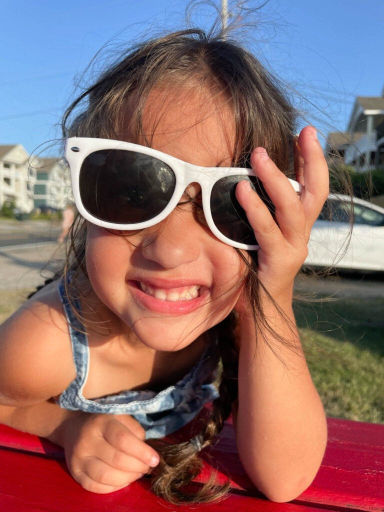 little girl wearing kid sunglasses