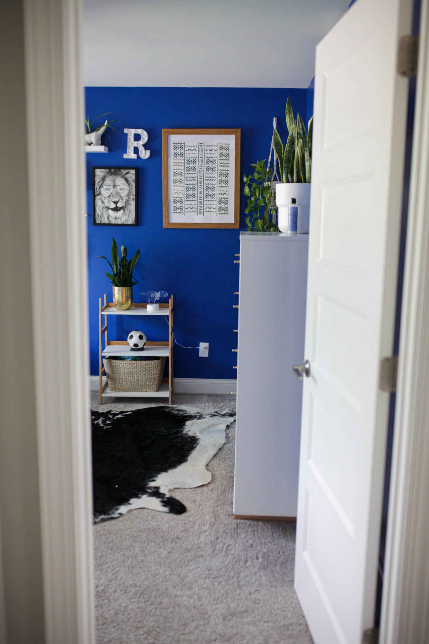 View into bright blue boys bedroom