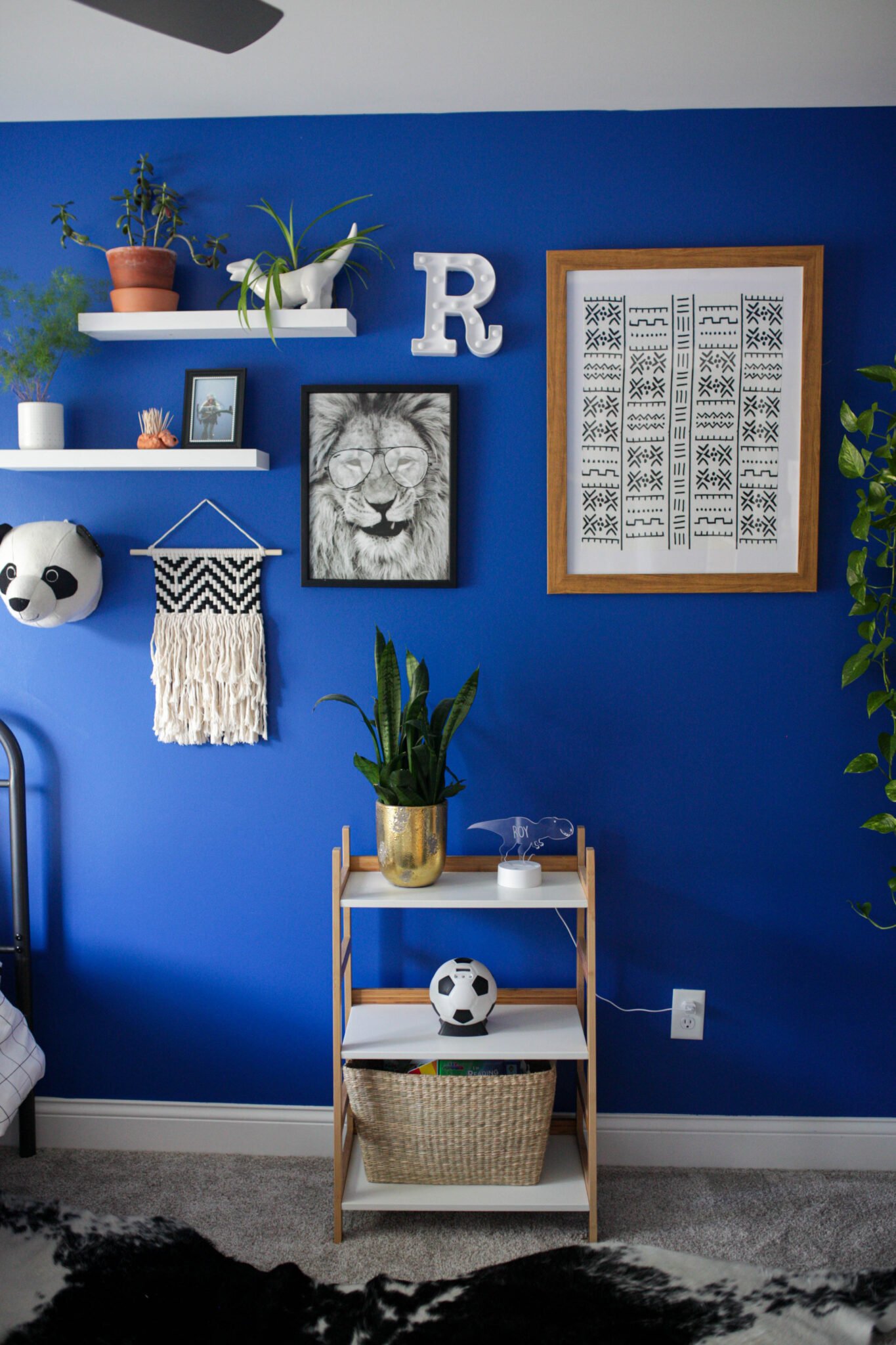 Gallery wall in bright blue boys bedroom