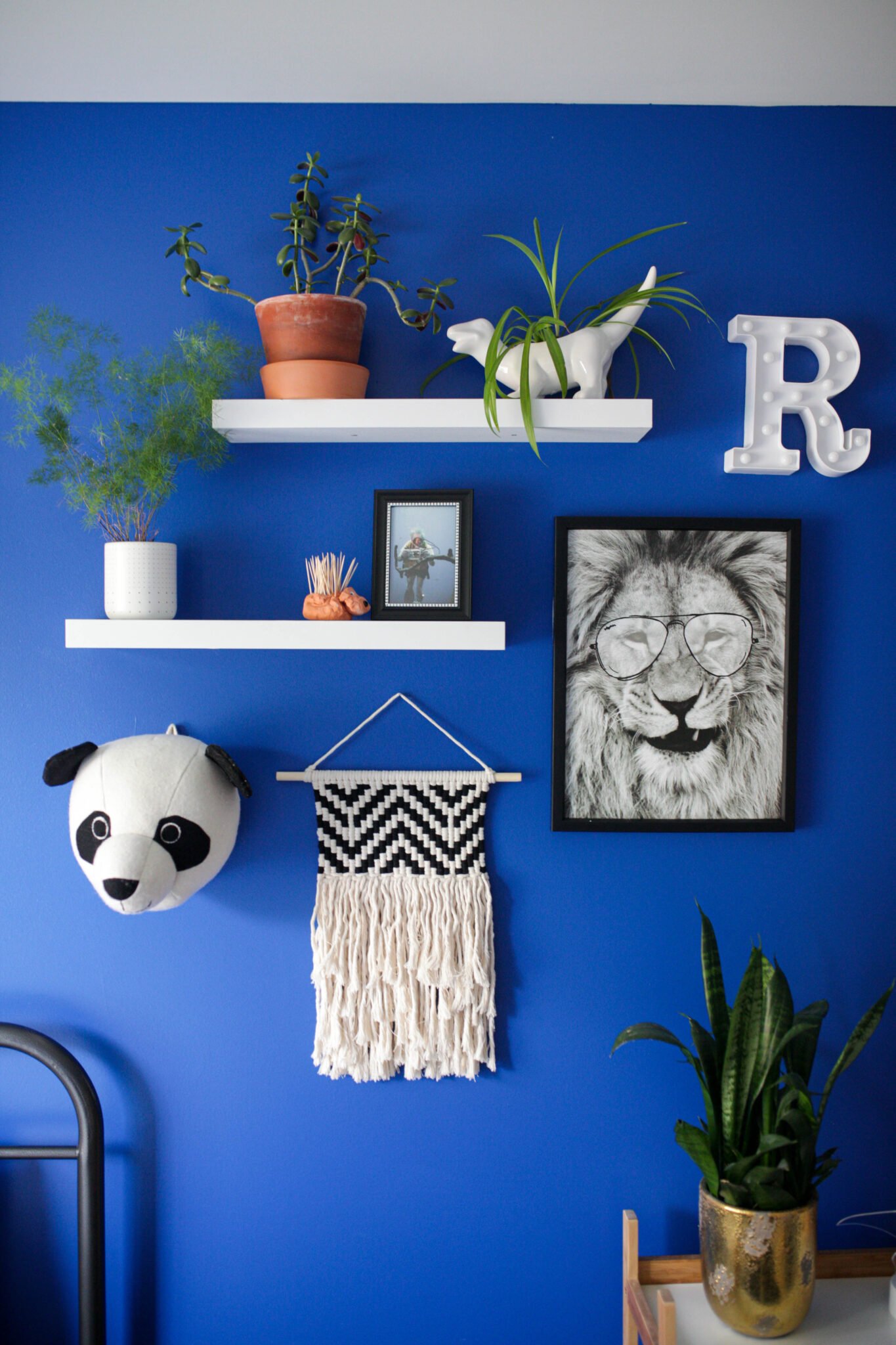 Gallery wall in bright blue boys bedroom