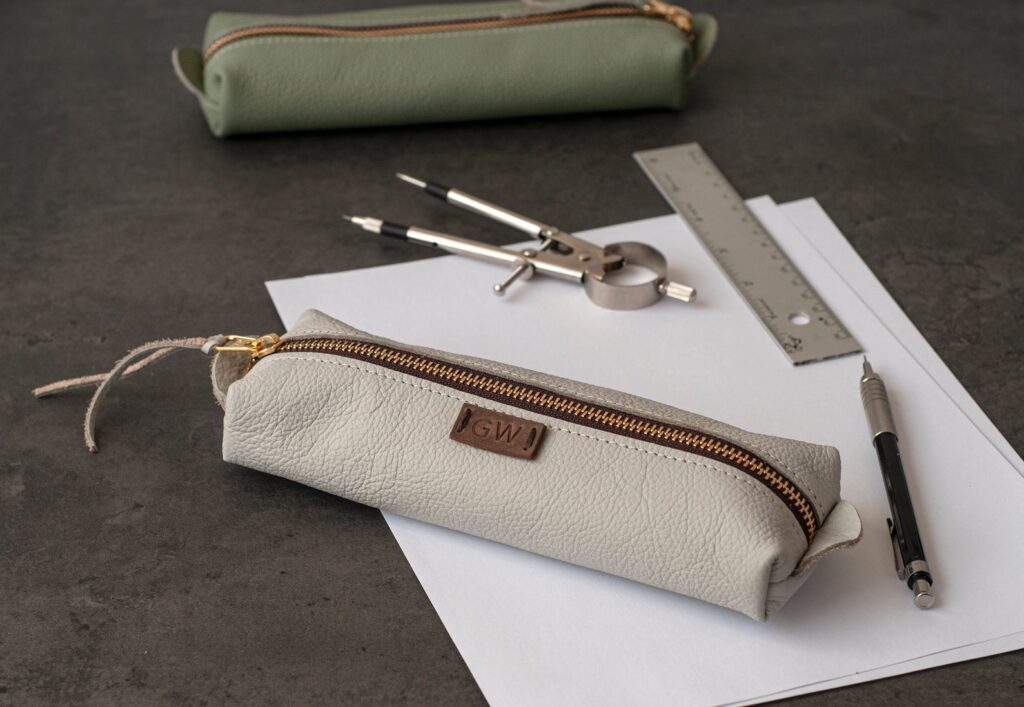 Leather pencil bag with initials on tag