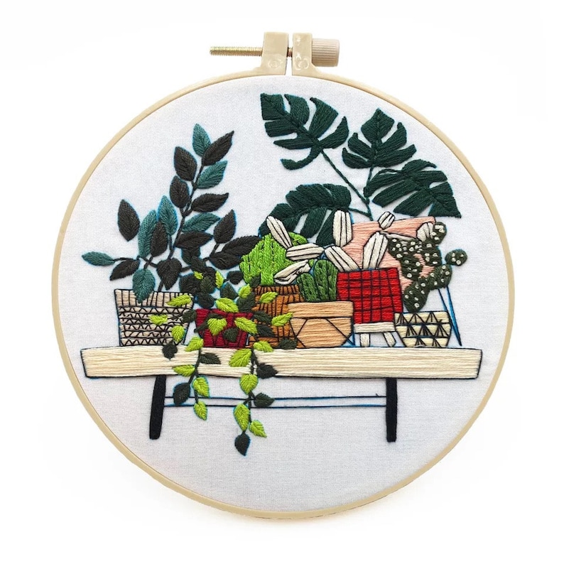 Embroidery hoop with embroidered collection of plants