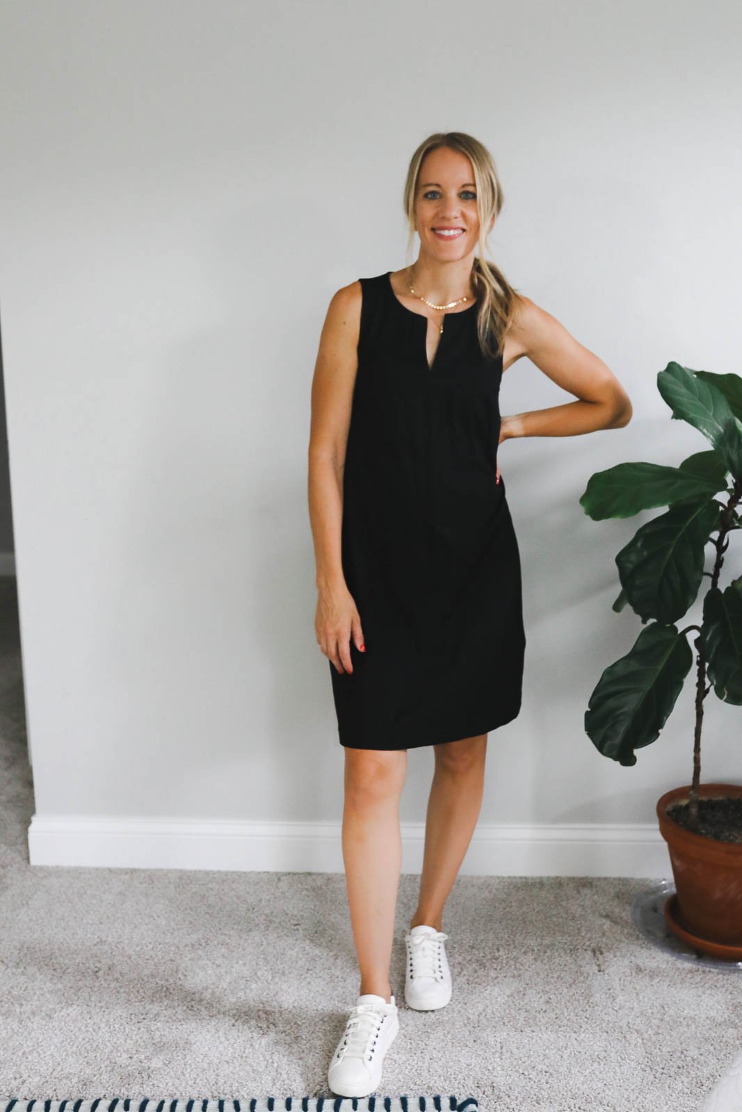 woman wearing a shift dress and white sneakers