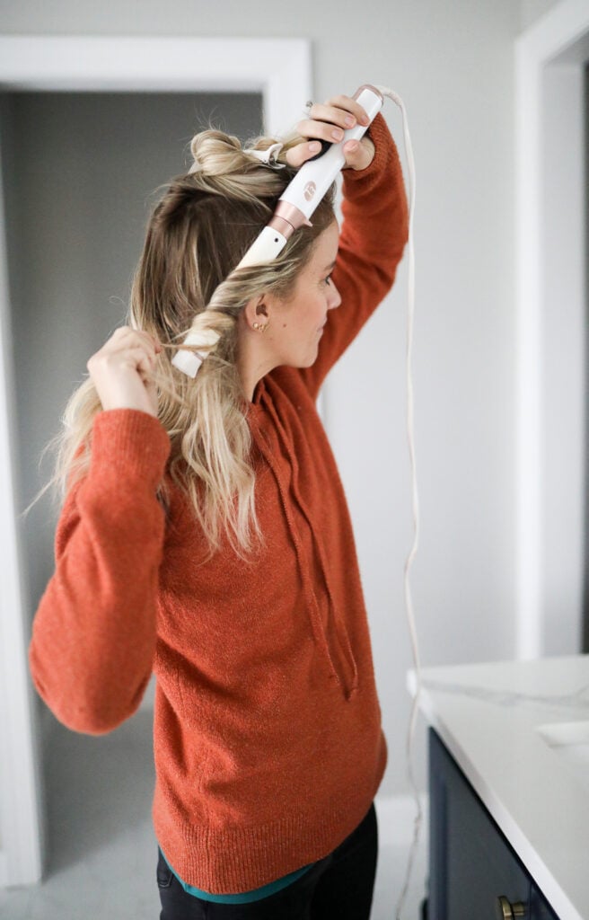 woman using a t3 curling wand