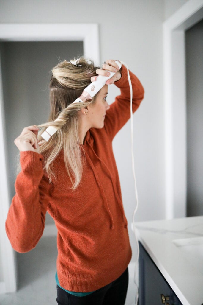 a woman using a curling wand