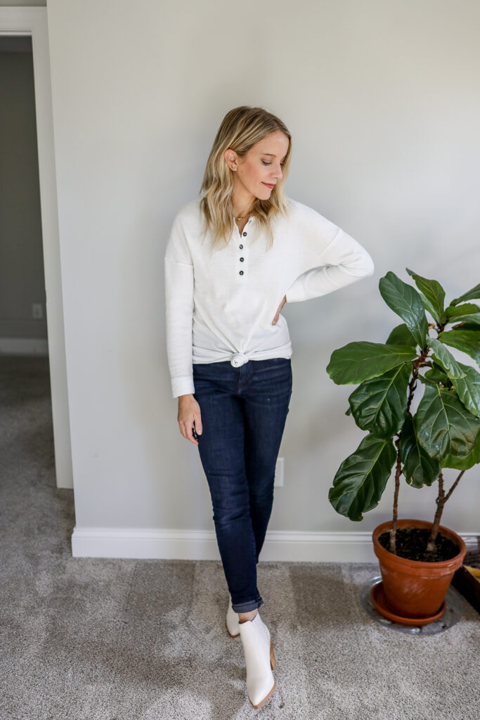 woman in white henley shirt and jeans