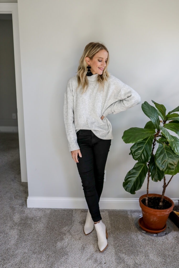 Girl wearing Black Jeans + Oversized Sweater + White Boots