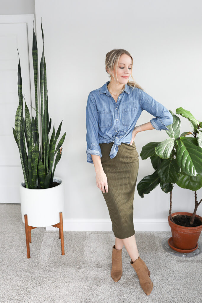 Woman wearing a denim shirt paired with a pencil skirt and booties