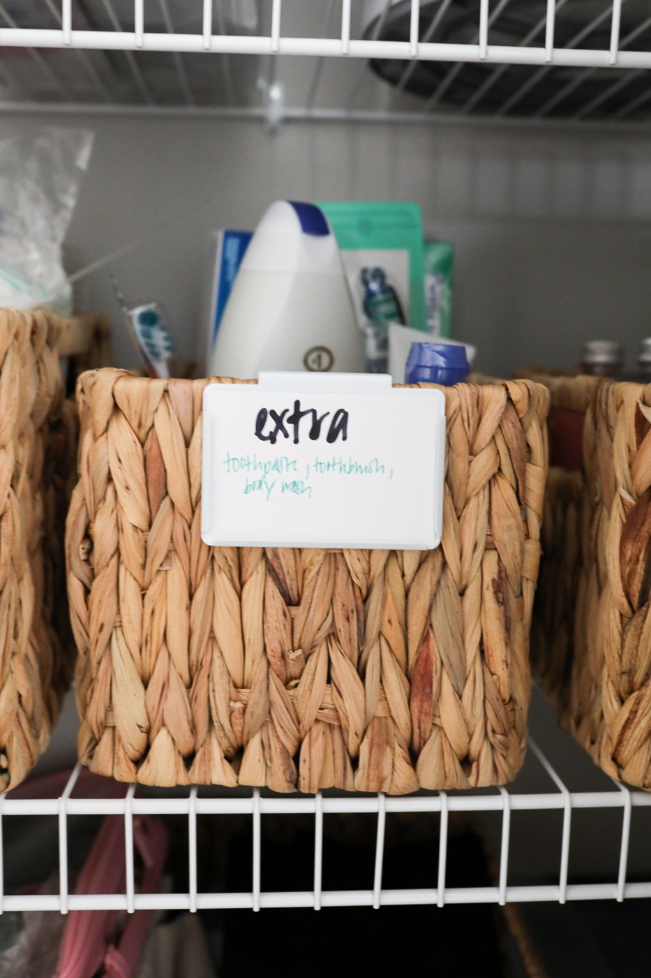 basket with label in linen closet