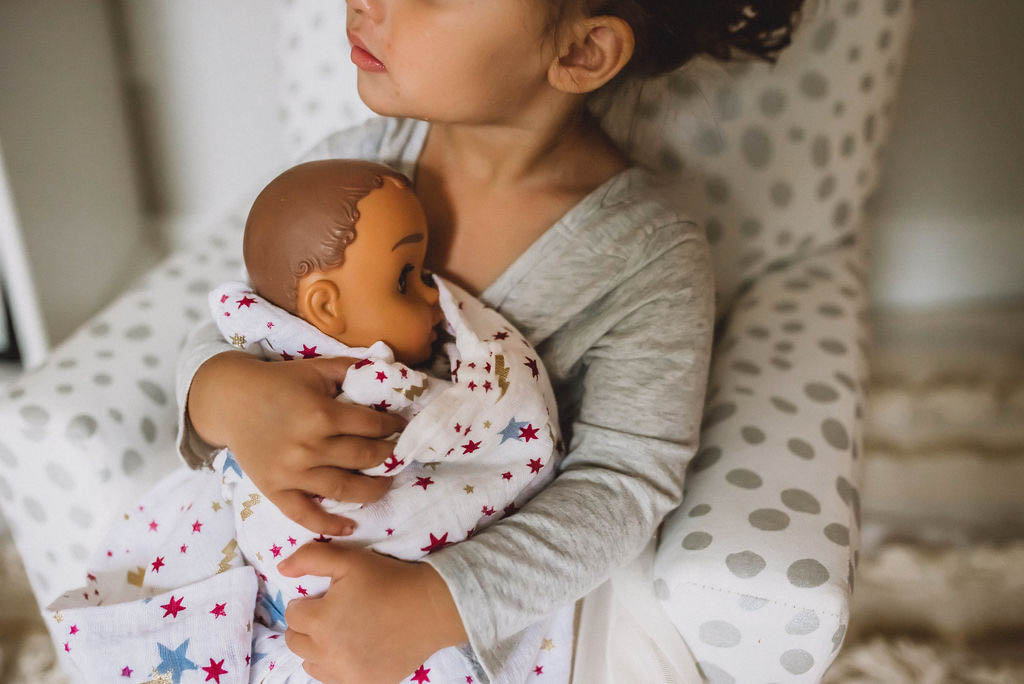 girl holding baby doll
