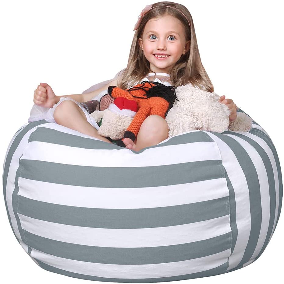 Girl sitting on bean bag holding stuffed animals