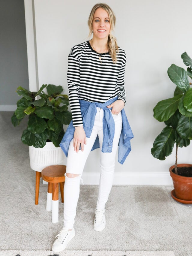 woman wearing white jeans with black and white strip top and chambray shirt around waist