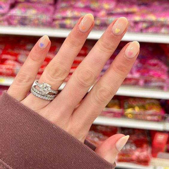 nude nails with colored hearts