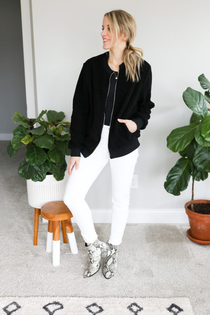 woman wearing White Jeans, Black Jacket and Animal Print Booties