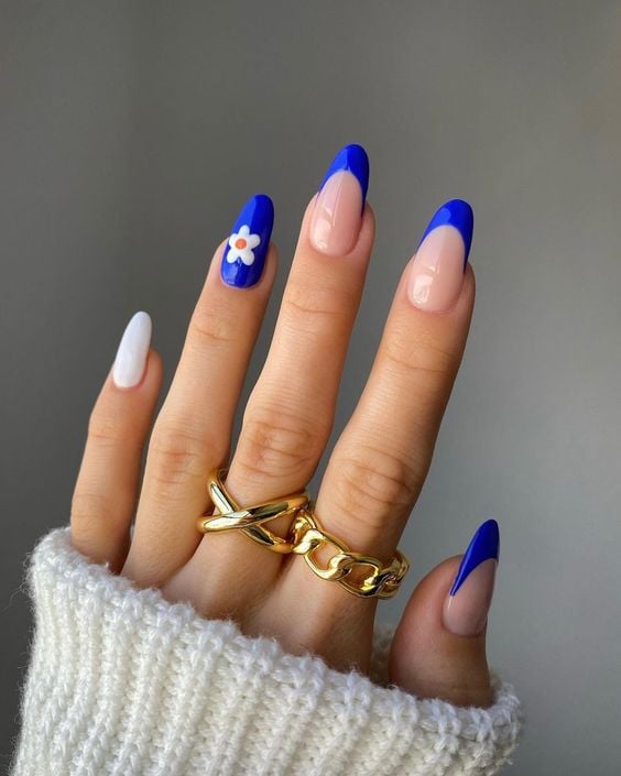 bright blue french tip with flower on ring finger