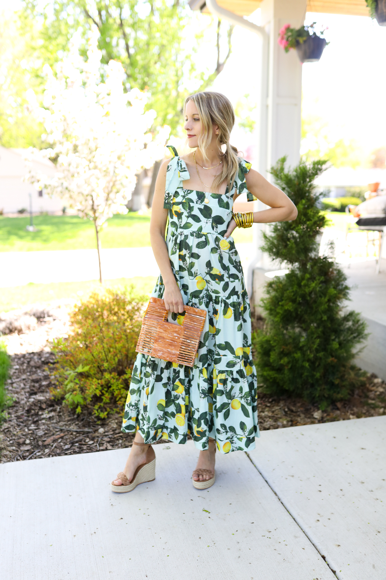 woman in long maxi dress holding handbag