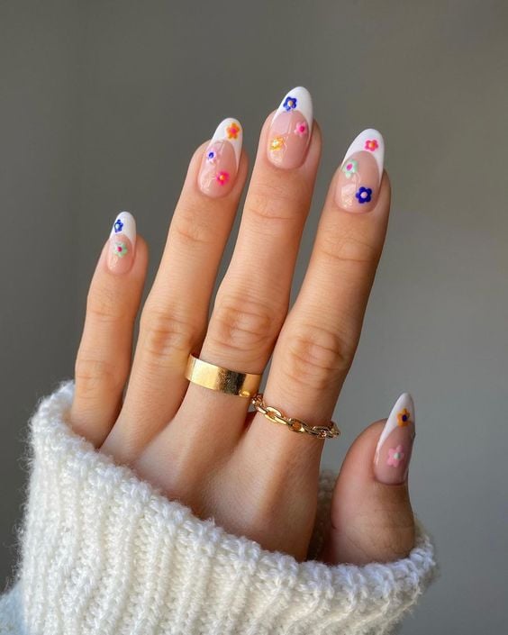 Woman's nails with white french tips with flowers.