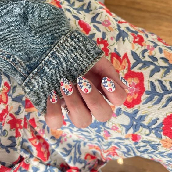 white base with flowers nail art