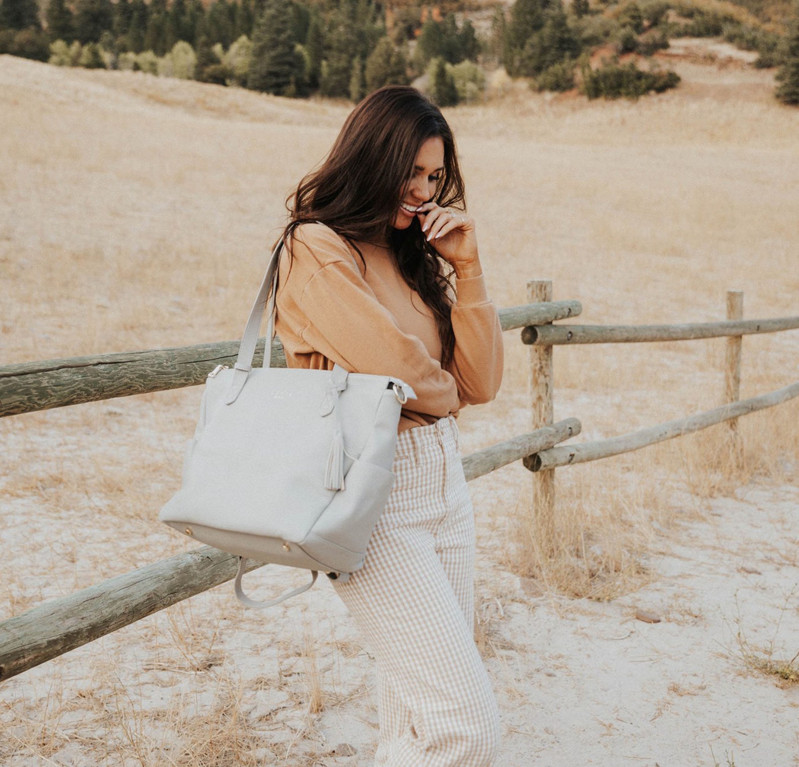 Woman holding Elkie and Co. Aberdeen Diaper Bag