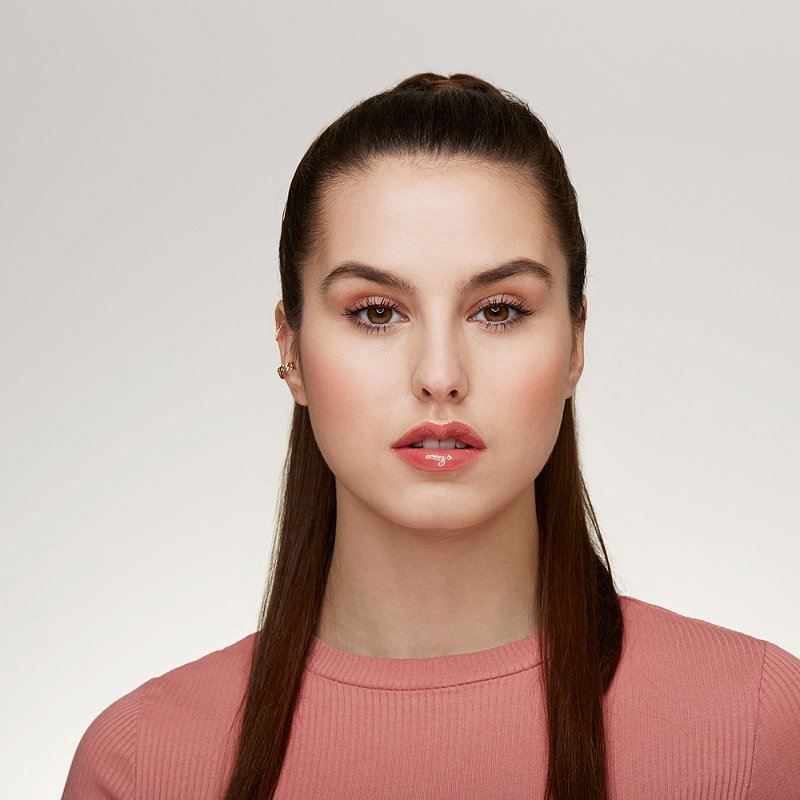 Woman wearing Essence Extreme Shine Volume Lipgloss