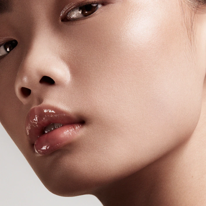 Close up of woman wearing Fenty Beauty by Rihanna – Gloss Bomb Universal Lip Luminizer