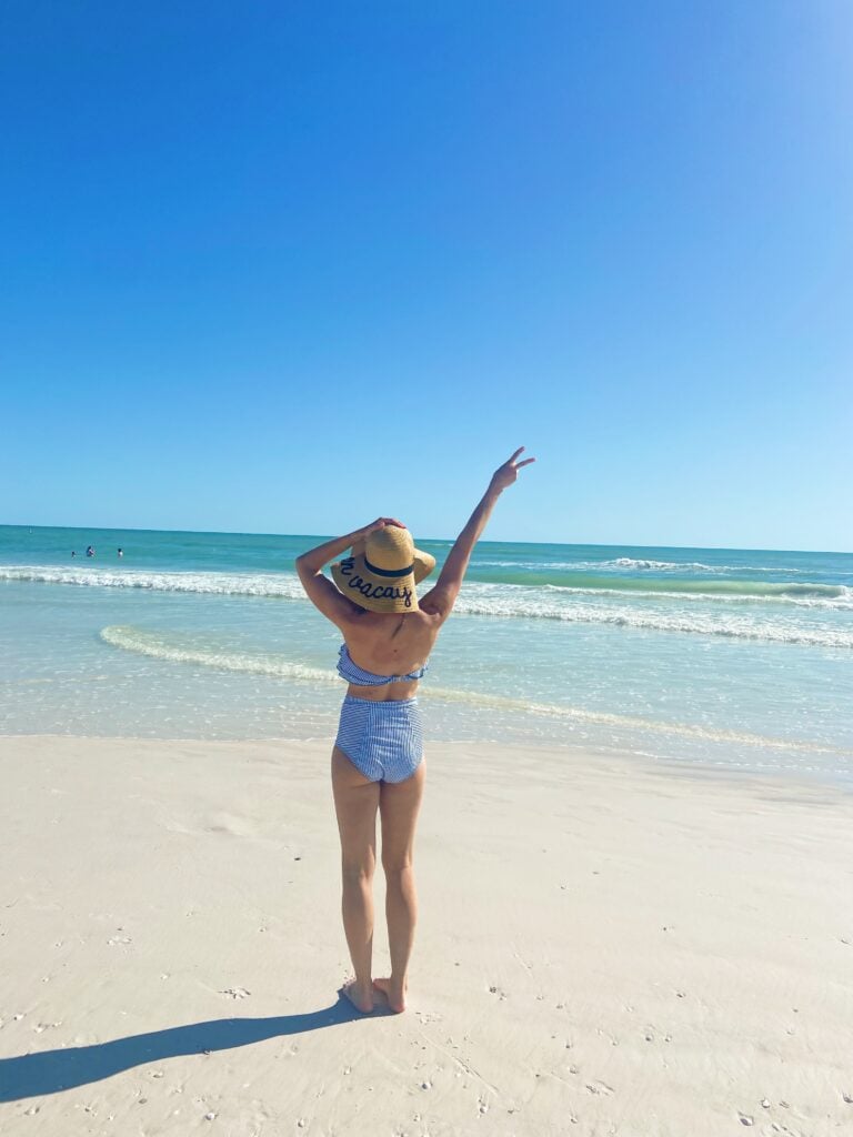 woman on beach with bikini and straw hat