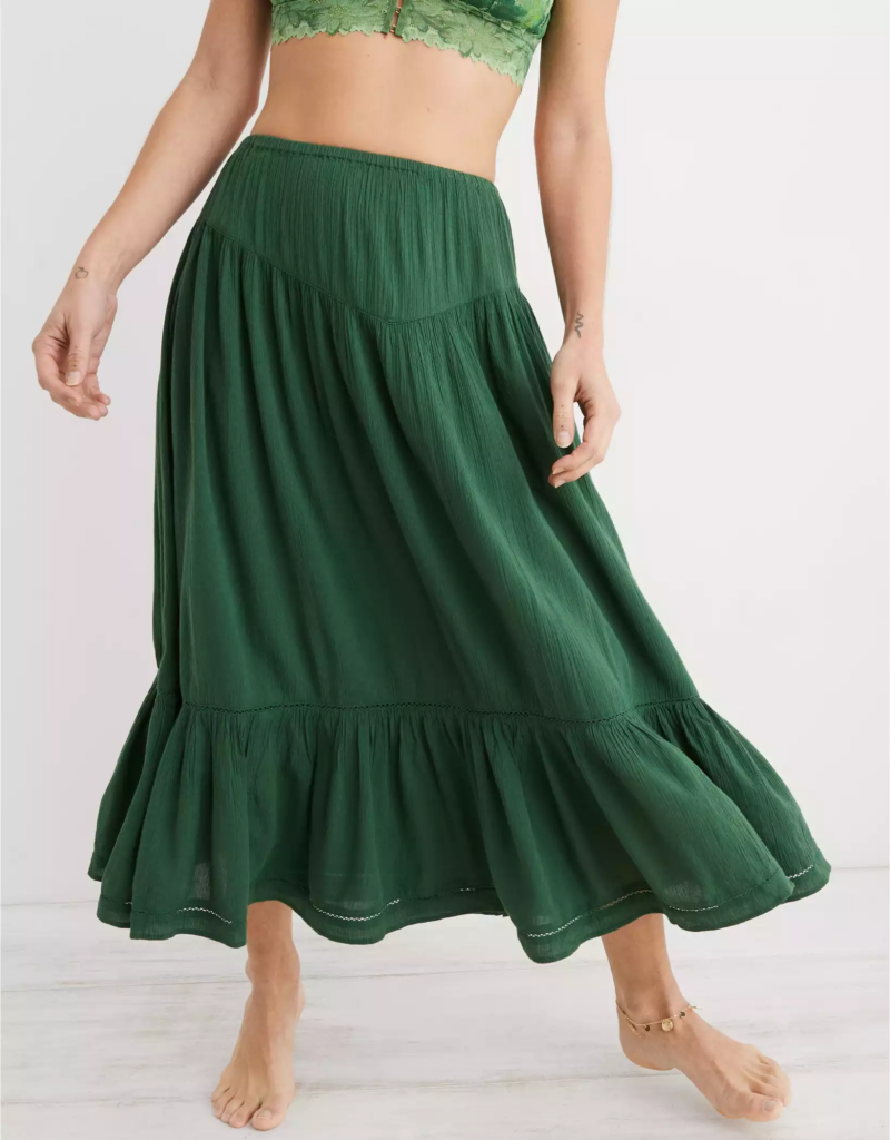 Woman wearing a green yoke waist skirt and ankle bracelet