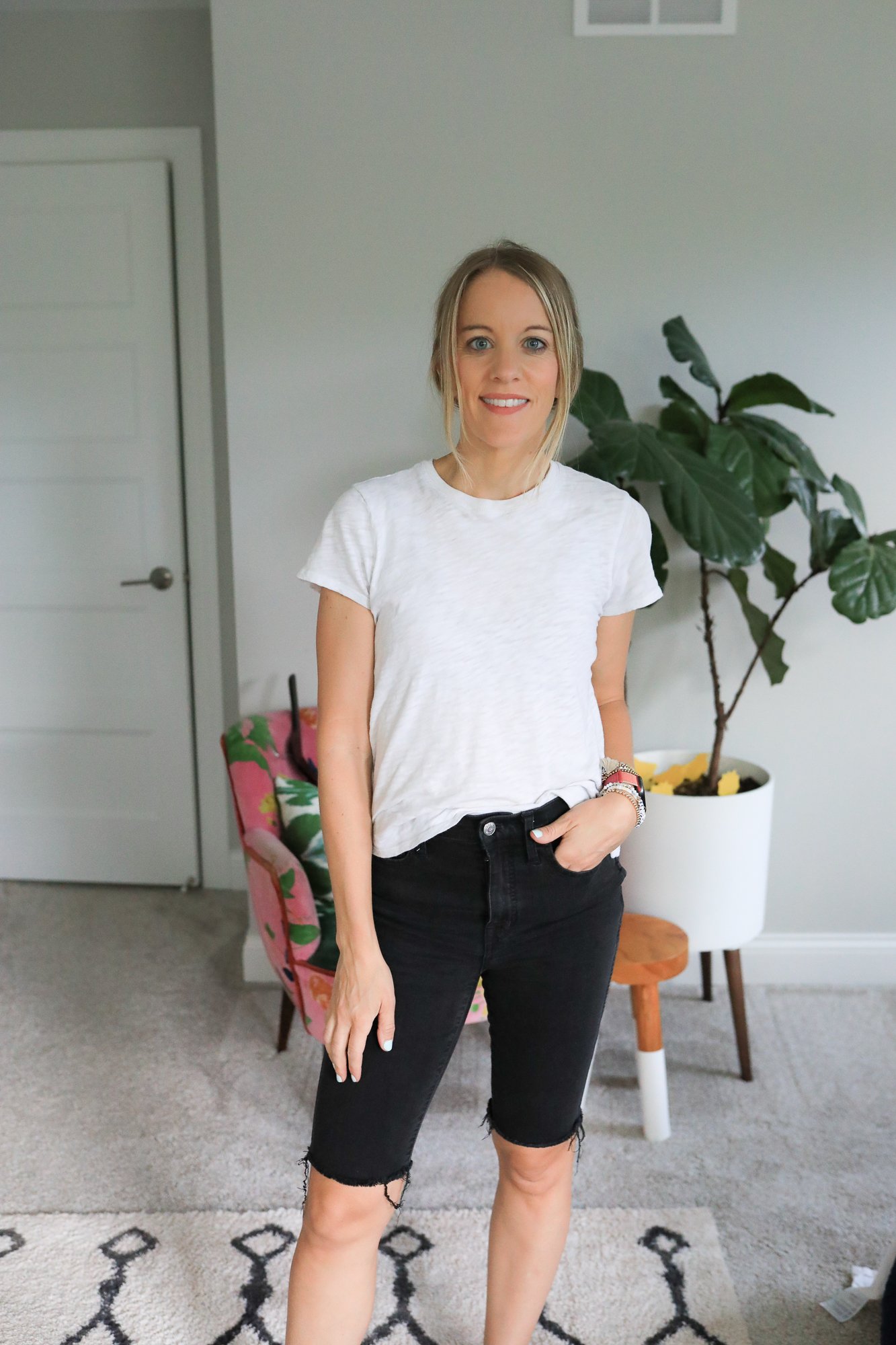 woman wearing bermuda jean shorts and white tee