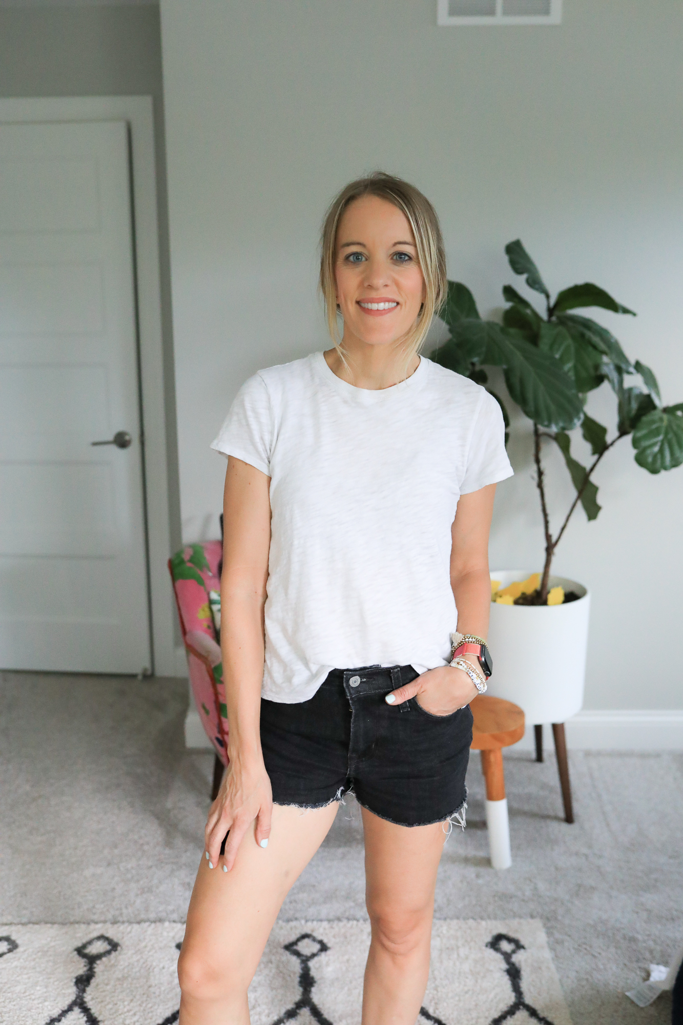 woman wearing black jean shorts and white tee