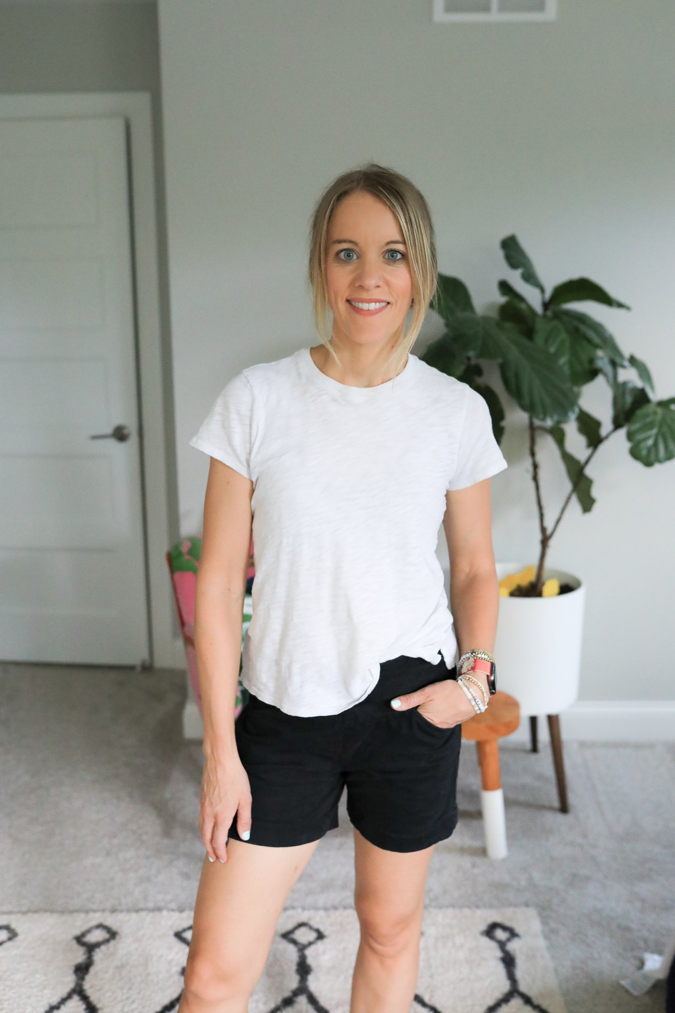 woman wearing jean shorts and white tee