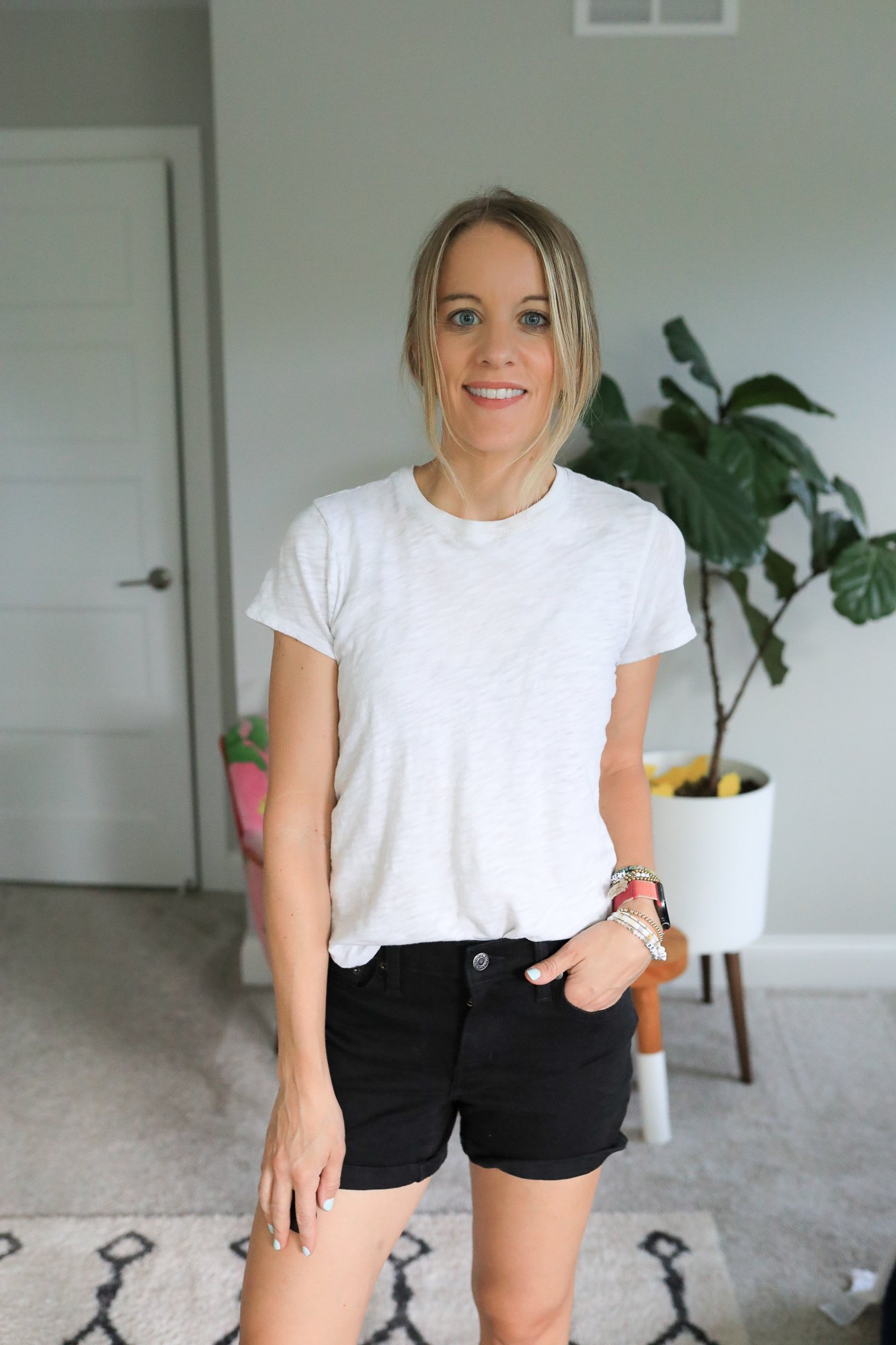 woman wearing jean shorts and white tee