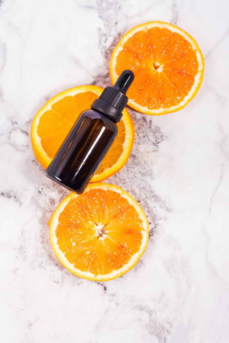 serum bottle and oranges