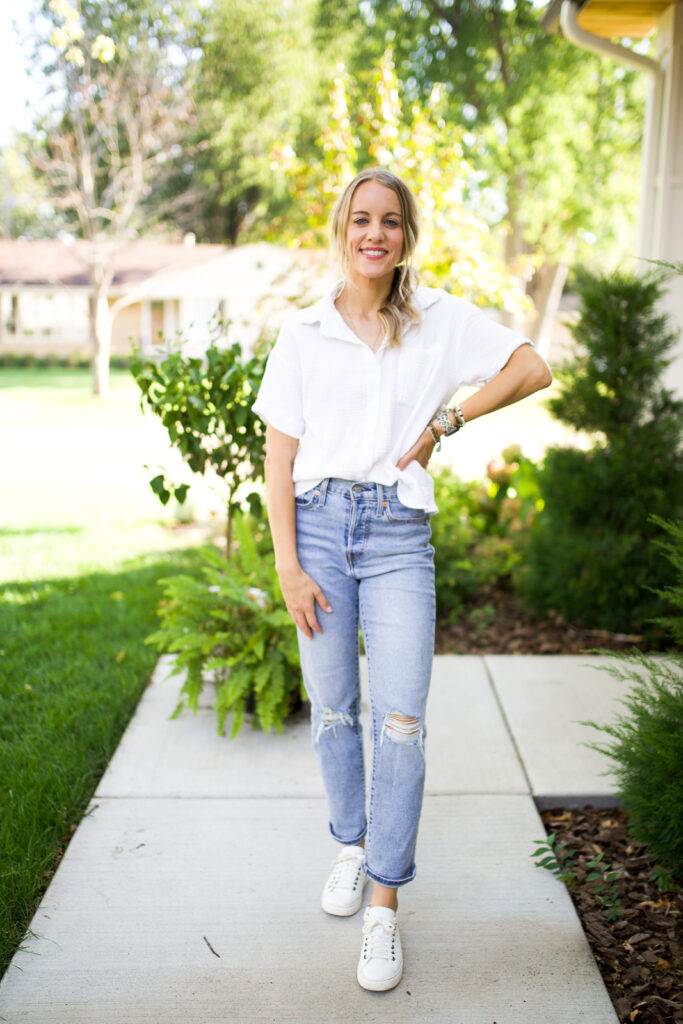 woman in jeans, white sneakers and a white button down