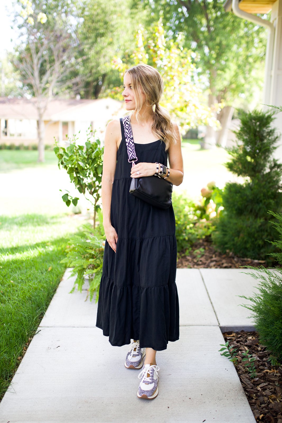 woman in black maxi dress and crossbody bag