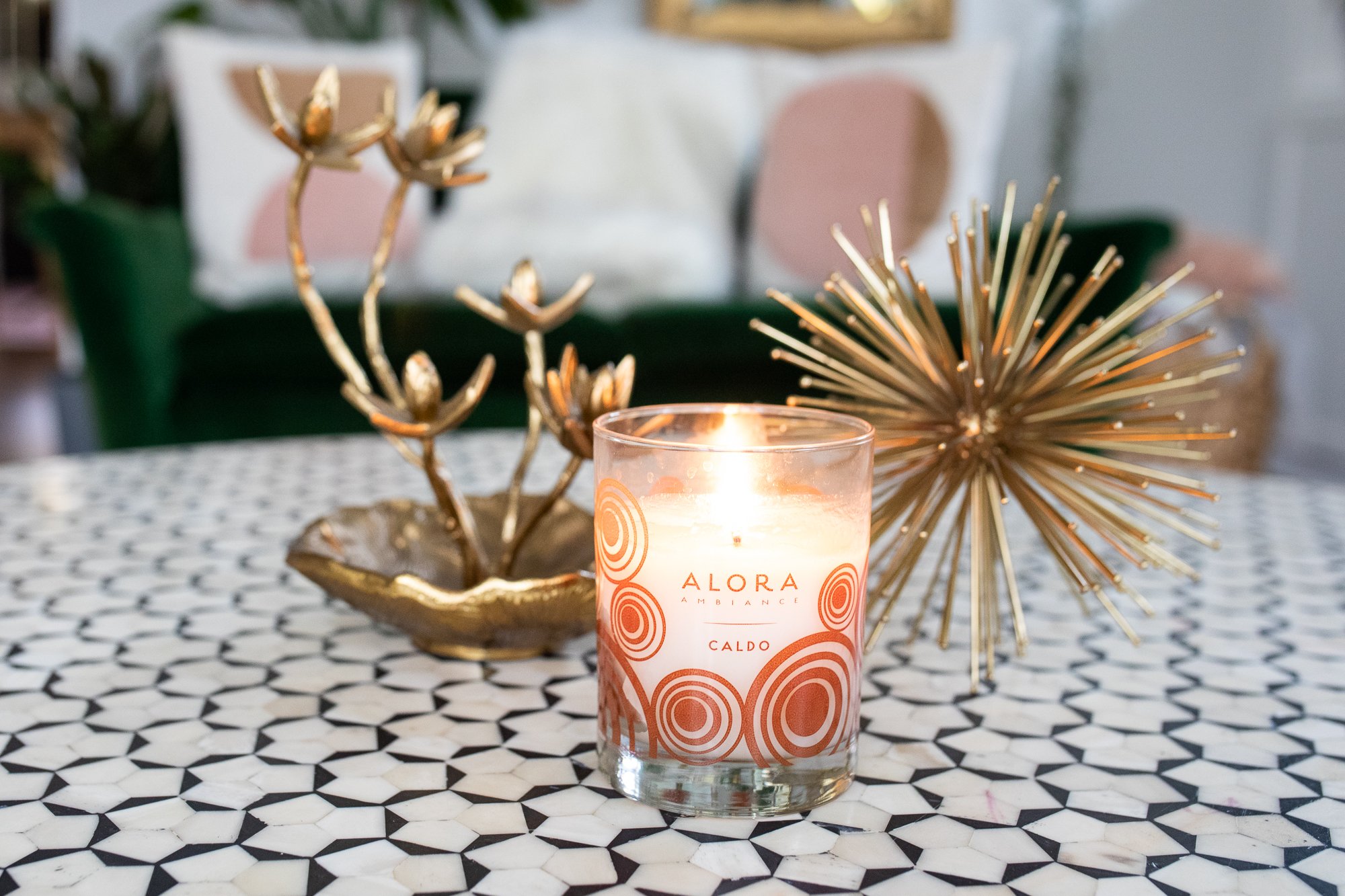 alora ambiance candle on table with gold accents