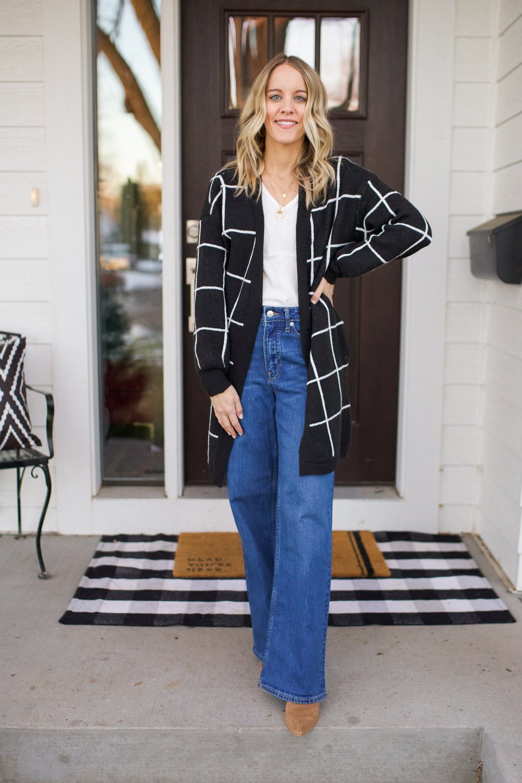 flare jeans and black and white sweater