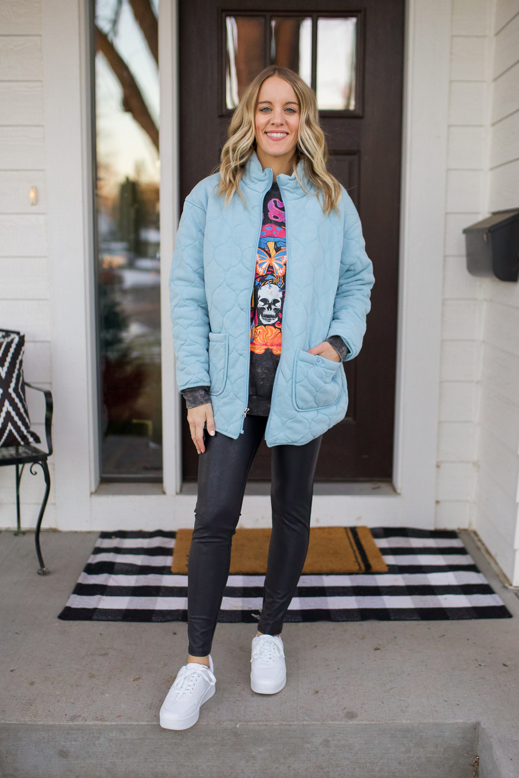 faux leather leggings and blue jacket and white sneakers