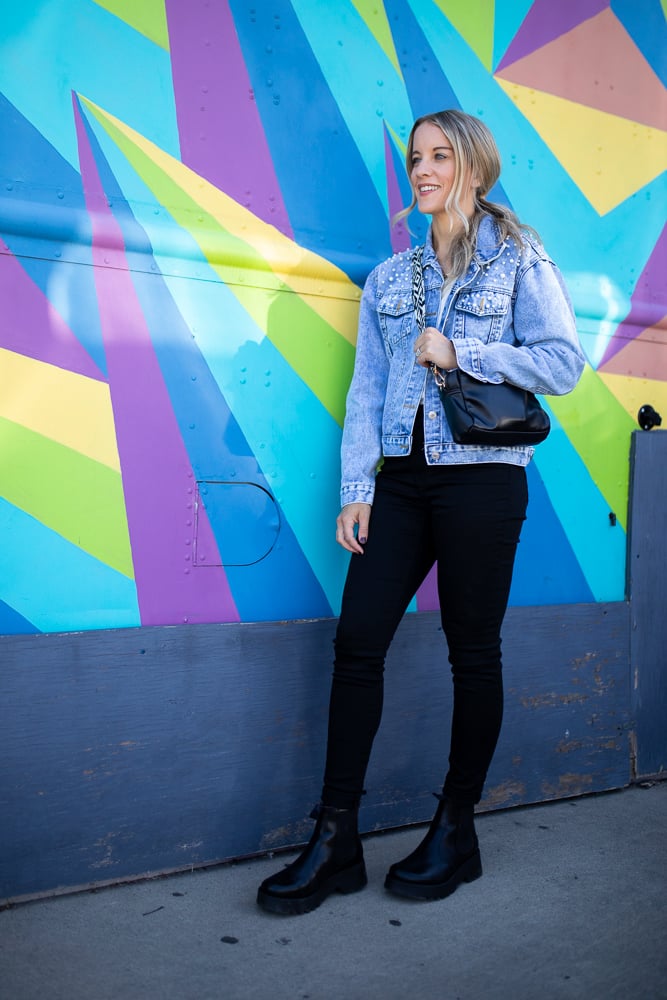 woman in black jeans, denim jacket and chelsea boots