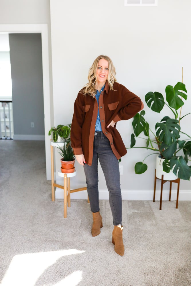 brown fleece jacket, grey jeans and brown boots